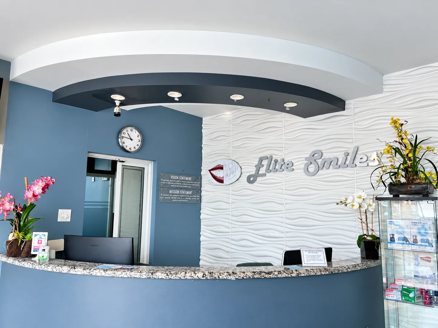 The Elite Smiles reception desk and branded feature wall